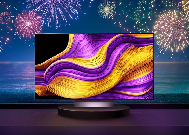 불꽃이 터지고 있는 배경 앞에 LG 올레드 스탠드형 TV가 중앙에 놓여져 있습니다.